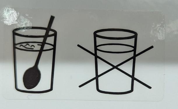 Two icons of drinking glasses with a liquid in them. The left one has a spoon in ti. The right one does not and is crossed out.